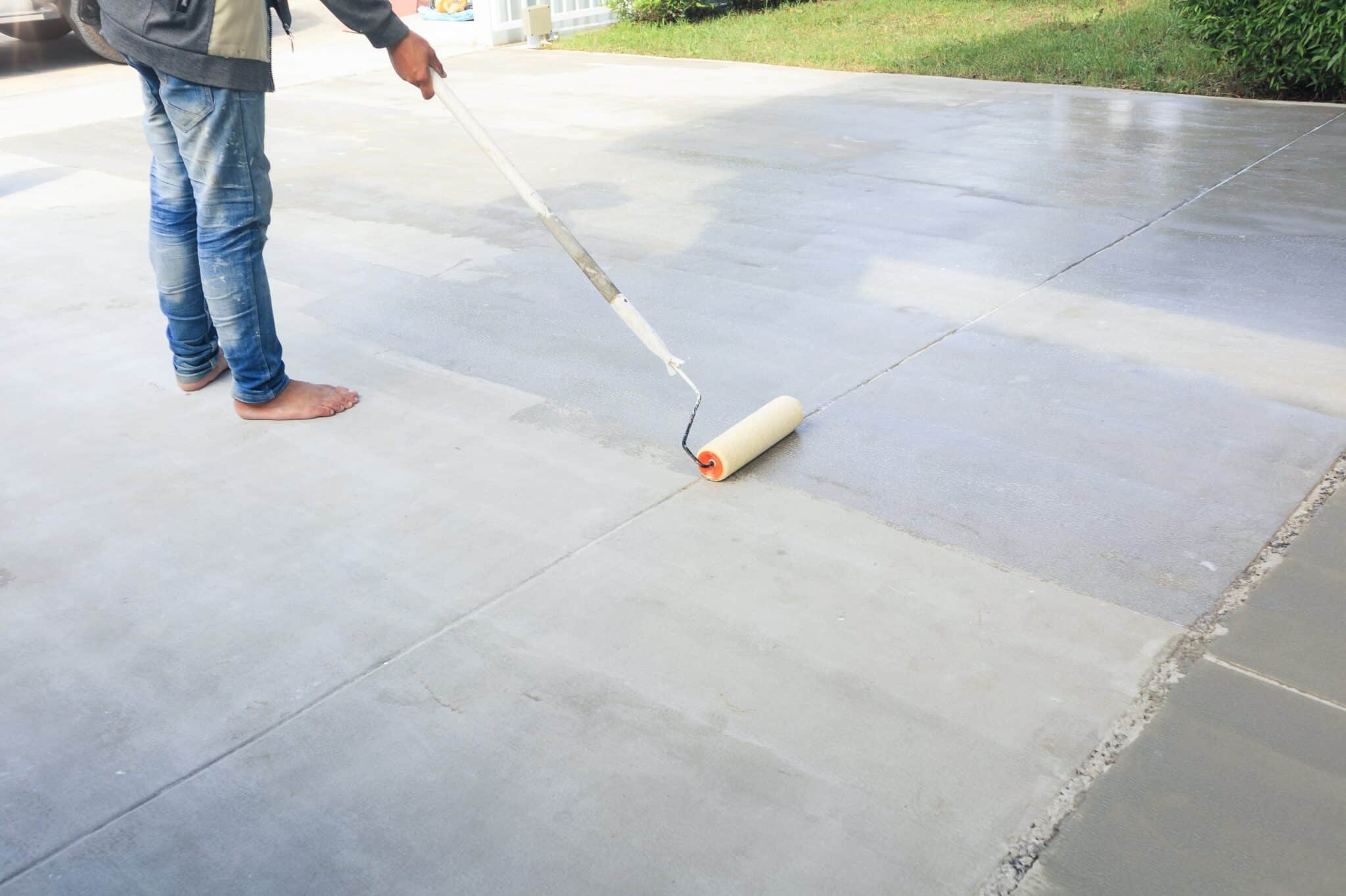 Worker and renovation work To using roller painting mortar cement or finishing material for repair crack skim coat or improvement surface of concrete pavement